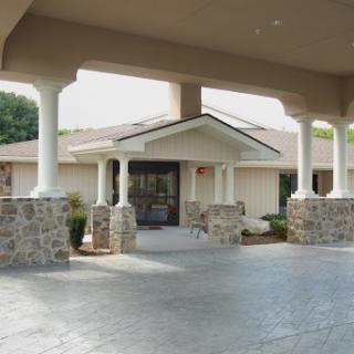 A welcoming entrance featuring elegant columns leading to a well-designed home.