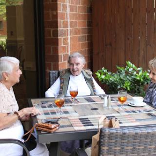 A delightful afternoon spent among friends, enjoying tea in a cozy outdoor setting.