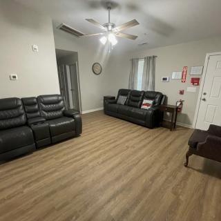 A spacious living room with comfortable seating and wood flooring.