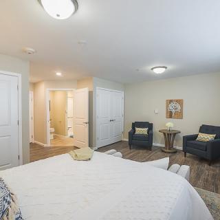 A modern bedroom interior with comfortable seating and neutral tones.