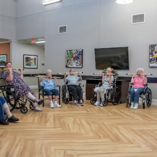 A group of senior citizens engaged in a social activity in a community center.