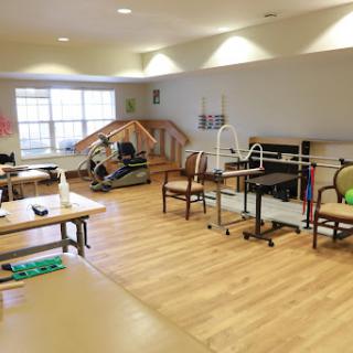 A spacious and well-equipped physical therapy room designed for rehabilitation exercises.