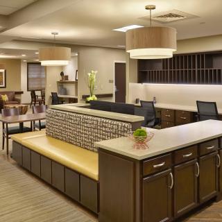 A modern lobby with a spacious reception desk and seating area.