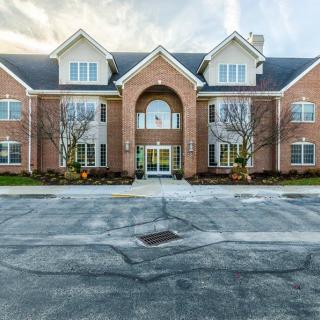 A two-story brick apartment building with symmetrically placed windows and a central entrance.