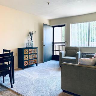 A bright and cozy living room with modern furniture and large windows.