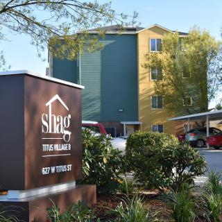 Exterior view of a hotel showcasing its entrance and landscaping.