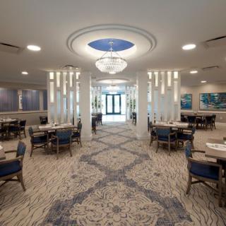 A modern and elegant restaurant interior with stylish chandeliers and comfortable seating arrangements.