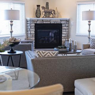 A beautifully designed living room featuring a cozy fireplace and modern furnishings.