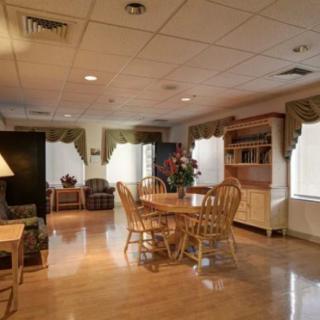 A cozy dining area with wooden furniture and natural lighting.