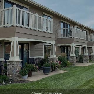 Modern apartment complex with balconies and landscaped surroundings.