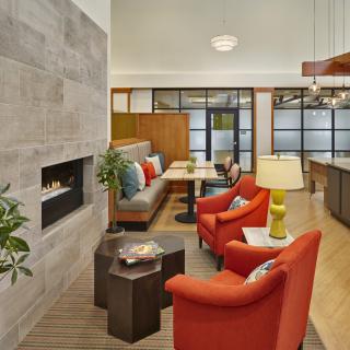 A modern living room with comfortable seating, a fireplace, and stylish decor.