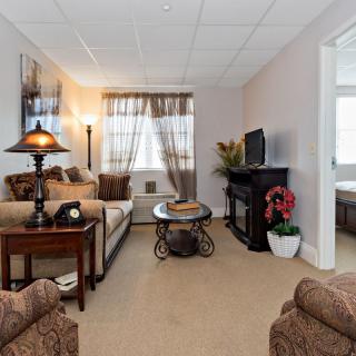 A cozy living room with comfortable seating and warm lighting.