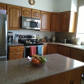 A modern kitchen with wooden cabinets and stainless steel appliances.