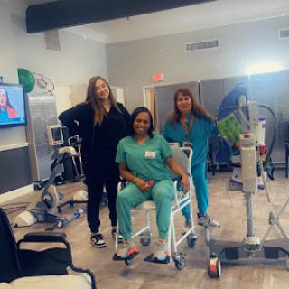 Healthcare professionals working together to support patient recovery in a rehabilitation setting.