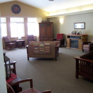 A cozy lounge area with comfortable seating and ample natural light.