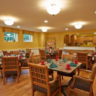 A cozy dining room setup with neatly arranged tables and chairs.