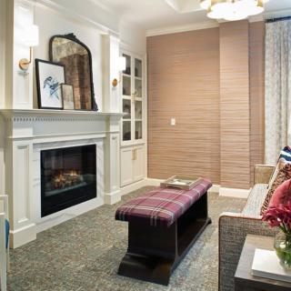 A cozy living room featuring a modern fireplace, elegant decor, and comfortable furnishings.