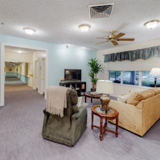 A cozy living room area featuring comfortable furniture and bright lighting.