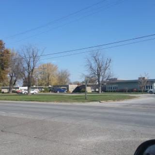 A view of a building surrounded by trees on a clear day.