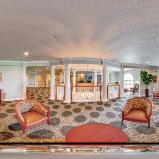 Spacious lobby with elegant seating and decorative architecture.