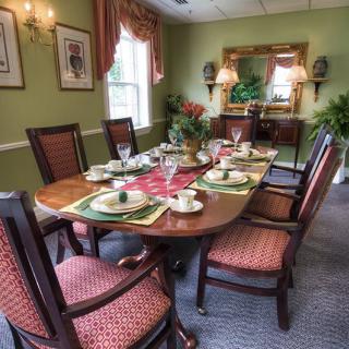 A traditional dining room with an elegantly set table.