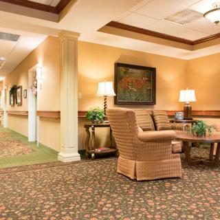 A warmly lit hallway with comfortable seating and elegant decor.