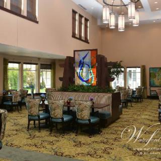 A modern dining area with stylish seating and elegant chandeliers.