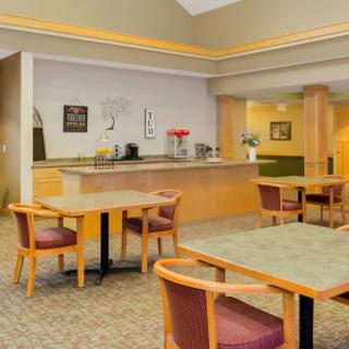 A casual dining area with tables and chairs in a cozy cafe setting.
