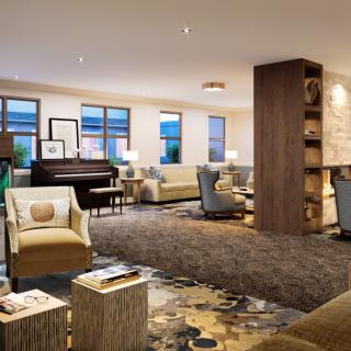 A cozy lounge with comfortable seating and a piano for entertainment.