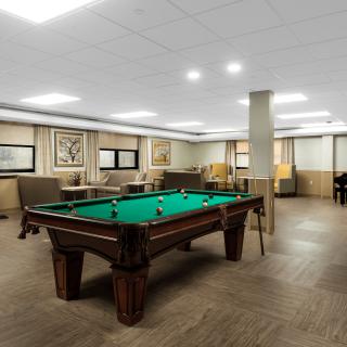 A spacious game room featuring a pool table, comfortable seating, and stylish decor.