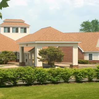 A charming residential building surrounded by lush greenery.