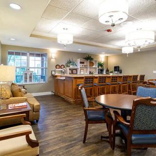 A cozy interior featuring a combined living and dining area with comfortable seating and a small bar.