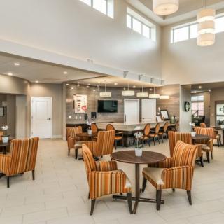 A modern lounge area with comfortable seating and bright lighting.