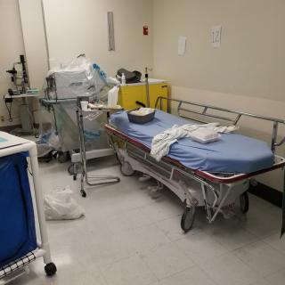 A hospital room with medical equipment and a bed.