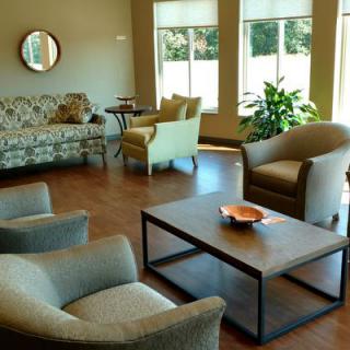 A cozy living room with modern furniture and large windows.