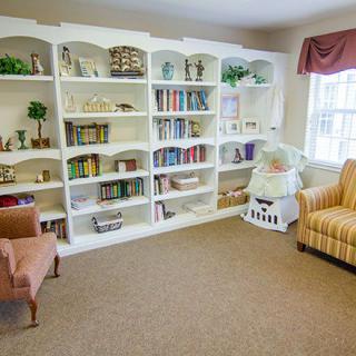 A cozy reading area with bookshelves and comfortable armchairs.