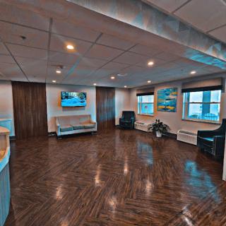 A spacious and modern waiting area featuring comfortable seating and contemporary decor.