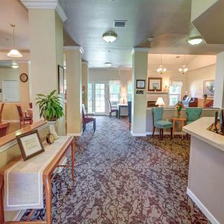 A spacious and well-lit lounge area with comfortable seating and elegant decor.