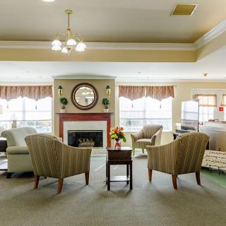 A cozy living room with a fireplace and comfortable seating arrangement.