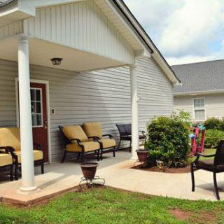 A cozy patio with comfortable outdoor seating and lush plants.