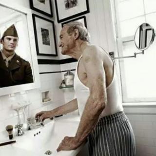An elderly man gazes into the mirror, seeing the reflection of his younger self as a soldier.