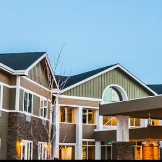 A contemporary residential building at dusk, showcasing modern architectural features.