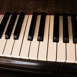 Close-up of piano keys showing black and white patterns.