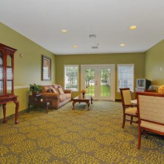 A cozy living room with comfortable seating and a view of the outdoors.