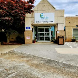 Entrance to a healthcare facility with clear signage and a well-maintained exterior.