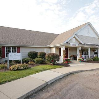 A suburban house with a landscaped entrance and sidewalk.