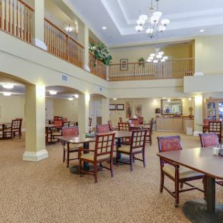 A cozy dining area featuring wooden furniture and ample space for guests.