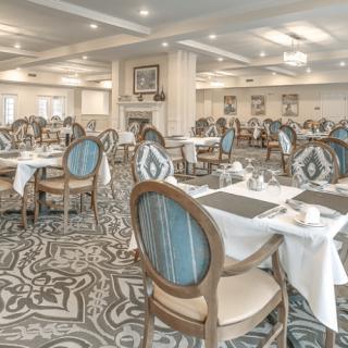 An elegant dining room with beautifully arranged tables and classic decor.