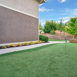 Well-maintained backyard with manicured lawn and garden.
