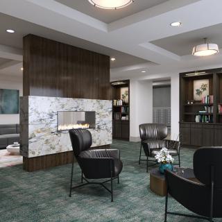 A modern lobby featuring a fireplace with contemporary seating and elegant chandeliers.